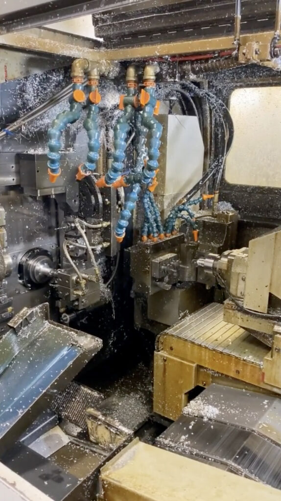 CNC Swiss-style machining in action. Image shows parts being precisely machined in the Swiss-Screw CNC Lathe